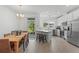 Modern kitchen with white cabinets, stainless steel appliances, and breakfast bar at 4119 Via Sienna Cir, Sarasota, FL 34243