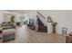 Open living room showcasing a spacious layout, hardwood floors, and a view into the kitchen at 4119 Via Sienna Cir, Sarasota, FL 34243