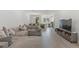 Open concept living room with large sectional sofa, hardwood floors and kitchen views at 4119 Via Sienna Cir, Sarasota, FL 34243