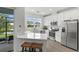 Modern kitchen with white cabinets, stainless steel appliances and access to the backyard at 4119 Via Sienna Cir, Sarasota, FL 34243
