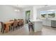 Kitchen and dining area with farmhouse table, hardwood floors, and access to backyard patio at 4119 Via Sienna Cir, Sarasota, FL 34243