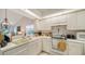 Well-equipped kitchen featuring white cabinetry and ample counter space at 208 Silver Lake Dr # 206, Venice, FL 34292