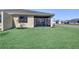Manicured backyard with a view of the screened in lanai at 18824 Dayspring Pl, Venice, FL 34293