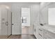 Bathroom featuring double vanities, a glass shower, and an open doorway to the bedroom at 18824 Dayspring Pl, Venice, FL 34293