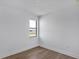 Bright bedroom featuring a modern window and wood-look flooring at 18824 Dayspring Pl, Venice, FL 34293