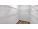 Walk-in closet with white wire shelving and wood-look flooring at 18824 Dayspring Pl, Venice, FL 34293