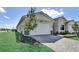 Charming single-story home featuring a two-car garage and a well-manicured front yard with stone driveway at 18824 Dayspring Pl, Venice, FL 34293