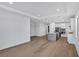 Open-concept kitchen with island, stainless steel appliances, and hardwood floors at 18824 Dayspring Pl, Venice, FL 34293