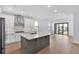 Bright kitchen featuring stainless steel appliances, island with seating, and tiled backsplash at 18824 Dayspring Pl, Venice, FL 34293