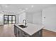 Kitchen island with sink, stainless steel faucet, and hardwood floors at 18824 Dayspring Pl, Venice, FL 34293