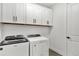 Laundry room featuring Whirlpool washer and dryer and white cabinets at 18824 Dayspring Pl, Venice, FL 34293