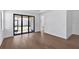 Living room featuring hardwood floors and sliding glass doors at 18824 Dayspring Pl, Venice, FL 34293