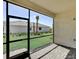 Screened-in patio overlooking lush green lawn and landscaping at 18824 Dayspring Pl, Venice, FL 34293