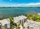 Aerial view of the condo complex with pristine bay waters in the background at 236 Hidden Bay Dr # 301, Osprey, FL 34229