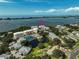 Aerial view of condo buildings with water view and community pool, tennis courts, and pond at 236 Hidden Bay Dr # 301, Osprey, FL 34229