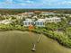 Scenic aerial view of the condos from over the water, showing the surrounding nature at 236 Hidden Bay Dr # 301, Osprey, FL 34229
