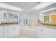 Bright bathroom featuring dual vanities, a jacuzzi tub, and ample storage space at 236 Hidden Bay Dr # 301, Osprey, FL 34229