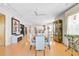 Bright dining area with hardwood floors and an open floor plan into the living and kitchen spaces at 236 Hidden Bay Dr # 301, Osprey, FL 34229
