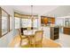 This dining area features a breakfast nook, hardwood floors, and leads into an open kitchen with granite counters at 236 Hidden Bay Dr # 301, Osprey, FL 34229