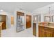 Bright kitchen featuring stainless steel appliances, wood cabinets, and white tile floors at 236 Hidden Bay Dr # 301, Osprey, FL 34229