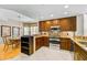 Open kitchen featuring wood cabinetry, stainless appliances, and granite countertops at 236 Hidden Bay Dr # 301, Osprey, FL 34229