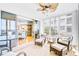 Well-lit sunroom featuring comfortable seating and sliding glass doors to the interior of the home at 236 Hidden Bay Dr # 301, Osprey, FL 34229