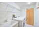 Functional laundry room features washer, dryer, sink, and plenty of storage shelving at 236 Hidden Bay Dr # 301, Osprey, FL 34229