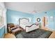 Serene bedroom with a decorative bed, plush chair, and an ensuite bathroom entrance at 236 Hidden Bay Dr # 301, Osprey, FL 34229