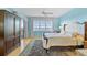 Main bedroom with water view features an en-suite bath, neutral paint and access to a private balcony at 236 Hidden Bay Dr # 301, Osprey, FL 34229