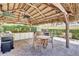 Outdoor kitchen and dining area with a thatched roof, barbecue grills, and ample seating at 236 Hidden Bay Dr # 301, Osprey, FL 34229