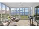 Enclosed patio with seating offering stunning waterfront views and ample natural light at 236 Hidden Bay Dr # 301, Osprey, FL 34229