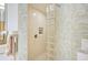 Stylish shower stall featuring glass block accents and white tile at 236 Hidden Bay Dr # 301, Osprey, FL 34229