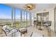 Relax in this sunroom with tile flooring, ceiling fan and gorgeous views of the water through floor to ceiling windows at 236 Hidden Bay Dr # 301, Osprey, FL 34229