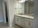Bathroom featuring double vanity with granite countertop and modern fixtures at 5661 Gaffney Rd, North Port, FL 34286