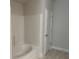Clean bathroom featuring a white tiled shower and tub combination at 5661 Gaffney Rd, North Port, FL 34286