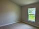Neutral bedroom with carpet and window offering natural light and a view of the outdoors at 5661 Gaffney Rd, North Port, FL 34286