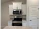 Modern kitchen showcasing stainless steel appliances, granite countertops, and sleek white cabinetry at 5661 Gaffney Rd, North Port, FL 34286