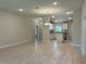 Open-concept living room and kitchen with neutral walls and modern lighting fixtures at 5661 Gaffney Rd, North Port, FL 34286
