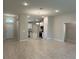 Spacious living area with open floor plan showcasing the kitchen and front entrance at 5661 Gaffney Rd, North Port, FL 34286