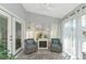 Bright sunroom with French doors and comfortable seating at 267 Chartley N Ct, Sarasota, FL 34232