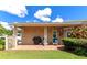 Covered patio with grill, seating area, and lush landscaping at 267 Chartley N Ct, Sarasota, FL 34232