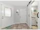 Entryway with whitewashed walls, barn door, and wood-look flooring at 267 Chartley N Ct, Sarasota, FL 34232