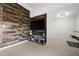 Living room with wood-look accent wall and media console at 10194 Thames Ave, Englewood, FL 34224