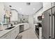 Modern kitchen with white cabinets, stainless steel appliances, and quartz countertops at 10194 Thames Ave, Englewood, FL 34224