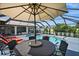 Inviting pool area with patio furniture and umbrella; great for entertaining at 10194 Thames Ave, Englewood, FL 34224