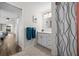Bright bathroom with white cabinets, shower, and view of bedroom at 10194 Thames Ave, Englewood, FL 34224