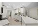Modern kitchen with white cabinets, quartz countertops, and stainless steel appliances at 10194 Thames Ave, Englewood, FL 34224