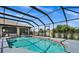 Inviting pool and spa area with screened enclosure and patio at 10194 Thames Ave, Englewood, FL 34224