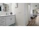 Clean bathroom with white vanity, mirror and view into bedroom at 10194 Thames Ave, Englewood, FL 34224