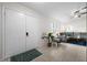 Bright entryway with tile flooring and double white doors at 10194 Thames Ave, Englewood, FL 34224